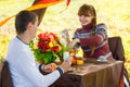 Beautiful Young Couple Having Picnic in autumn Park. Happy Family Outdoor. Smiling Man and Woman relaxing in Park. Relationships Royalty Free Stock Photo