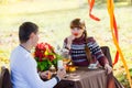 Beautiful Young Couple Having Picnic in autumn Park. Happy Family Outdoor. Smiling Man and Woman relaxing in Park. Relationships. Royalty Free Stock Photo