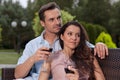 Beautiful young couple having red wine in park Royalty Free Stock Photo