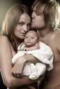 Beautiful young couple holding a baby (retouched) Royalty Free Stock Photo