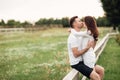 Beautiful young couple hugging and kissing outdoors in the park on a warm summer sunny day Royalty Free Stock Photo