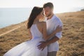 Beautiful young couple hugging in nature. People in white clothes. Royalty Free Stock Photo