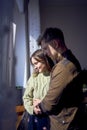 beautiful young couple kissing near the window Royalty Free Stock Photo