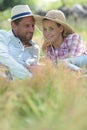 beautiful young couple laying on grass in urban park Royalty Free Stock Photo