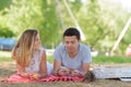 beautiful young couple laying on grass in urban park Royalty Free Stock Photo