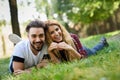 Beautiful young couple laying on grass in an urban park. Royalty Free Stock Photo