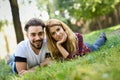 Beautiful young couple laying on grass in an urban park. Royalty Free Stock Photo