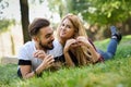 Beautiful young couple laying on grass in an urban park. Royalty Free Stock Photo