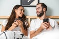 Beautiful young couple laying together in bed Royalty Free Stock Photo