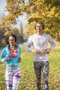 Beautiful young couple listening music and running together Royalty Free Stock Photo