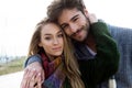 Beautiful young couple in love in a cold winter on the beach. Royalty Free Stock Photo