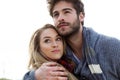 Beautiful young couple in love in a cold winter on the beach. Royalty Free Stock Photo