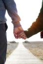 Beautiful young couple in love in a cold winter on the beach. Royalty Free Stock Photo