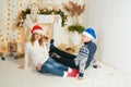 Beautiful young couple in love have fun on Christmas background
