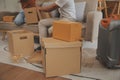 Beautiful young couple in love having fun unpacking things from cardboard boxes while moving in together in their new apartment Royalty Free Stock Photo