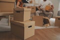 Beautiful young couple in love having fun unpacking things from cardboard boxes while moving in together in their new apartment Royalty Free Stock Photo