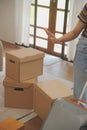 Beautiful young couple in love having fun unpacking things from cardboard boxes while moving in together in their new apartment Royalty Free Stock Photo