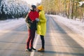 couple in love holding a big red heart on the background of winter snowy forest Royalty Free Stock Photo