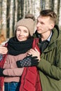 Beautiful young couple in love hugging in the park on a clear sunny winter day