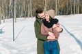 Beautiful young couple in love hugging and smiling in the park on a clear sunny winter day Royalty Free Stock Photo