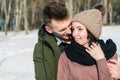 Beautiful young couple in love hugging and smiling in the park on a clear sunny winter day Royalty Free Stock Photo