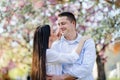 Beautiful young couple in love outside in spring nature, hugging. Royalty Free Stock Photo
