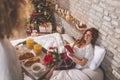 Husband bringing breakfast tray to his wife on Christmas morning Royalty Free Stock Photo