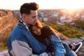 Beautiful young couple in love standing at a building rooftop at the sunset. Royalty Free Stock Photo