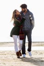 Beautiful young couple in love walking in a cold winter on the b Royalty Free Stock Photo