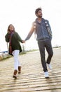 Beautiful young couple in love walking in a cold winter on the b Royalty Free Stock Photo