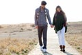 Beautiful young couple in love walking in a cold winter on the b Royalty Free Stock Photo