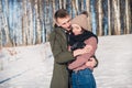 Beautiful young couple in love in a winter park on a clear sunny day Royalty Free Stock Photo