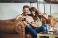 Young couple is making selfie using a smartphone and smiling while sitting in the cafe Royalty Free Stock Photo