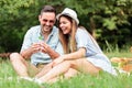 Beautiful young couple making a wish after finding four leaf clover