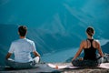 Practices yoga and meditates on mountains, peak Royalty Free Stock Photo