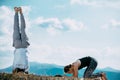 Practices yoga and meditates on mountains, peak Royalty Free Stock Photo