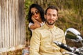 Beautiful young couple with a motorcycle