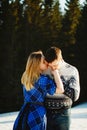 Beautiful young couple over amazingly snowy mountains