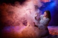 Beautiful young couple during a photo shoot with flour in a dark Studio. A young man and a girl pose together on a black Royalty Free Stock Photo