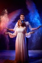 Beautiful young couple during a photo shoot with flour in a dark Studio. A young man and a girl pose together on a black Royalty Free Stock Photo