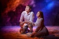 Beautiful young couple during a photo shoot with flour in a dark Studio. A young man and a girl pose together on a black Royalty Free Stock Photo