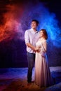 Beautiful young couple during a photo shoot with flour in a dark Studio. A young man and a girl pose together on a black Royalty Free Stock Photo