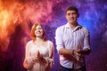 Beautiful young couple during a photo shoot with flour in a dark Studio. A young man and a girl pose together on a black Royalty Free Stock Photo