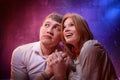 Beautiful young couple during a photo shoot with flour in a dark Studio. A young man and a girl pose together on a black Royalty Free Stock Photo