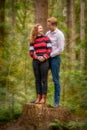 Beautiful young couple posing in the forest. looking in love at each other