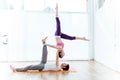 Beautiful young couple practicing yoga at home.