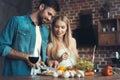 Beautiful young couple preparing a healthy meal together while spending free time at home. Royalty Free Stock Photo