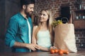 Beautiful young couple preparing a healthy meal together while spending free time at home. Royalty Free Stock Photo