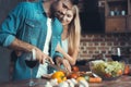 Beautiful young couple preparing a healthy meal together while spending free time at home. Royalty Free Stock Photo