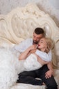 Beautiful young couple resting in bed. The bride and groom in bed. A young family on their wedding day. Wedding Dress Royalty Free Stock Photo